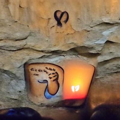Ancient Symbol Illuminated in Candlelit Cave