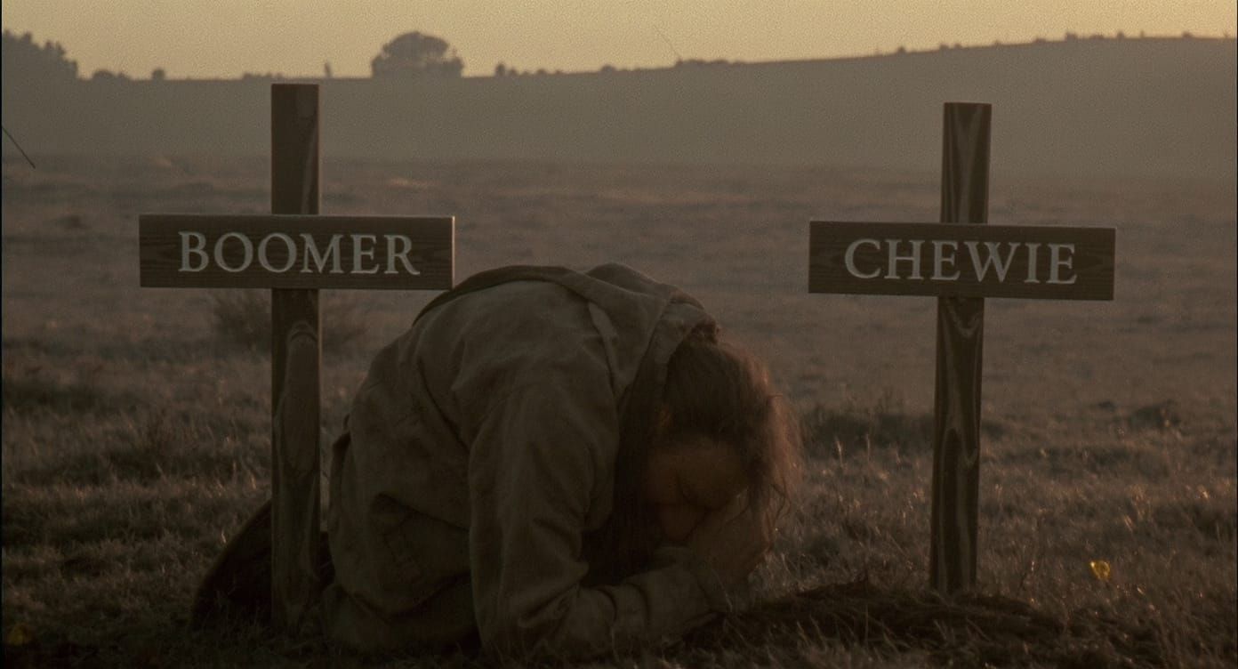 Man Grieving at Pet Cemetery at Dawn