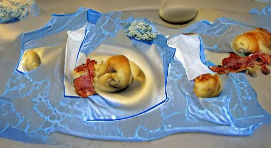 Raw Garlic Bacon Knots on Blue Plate