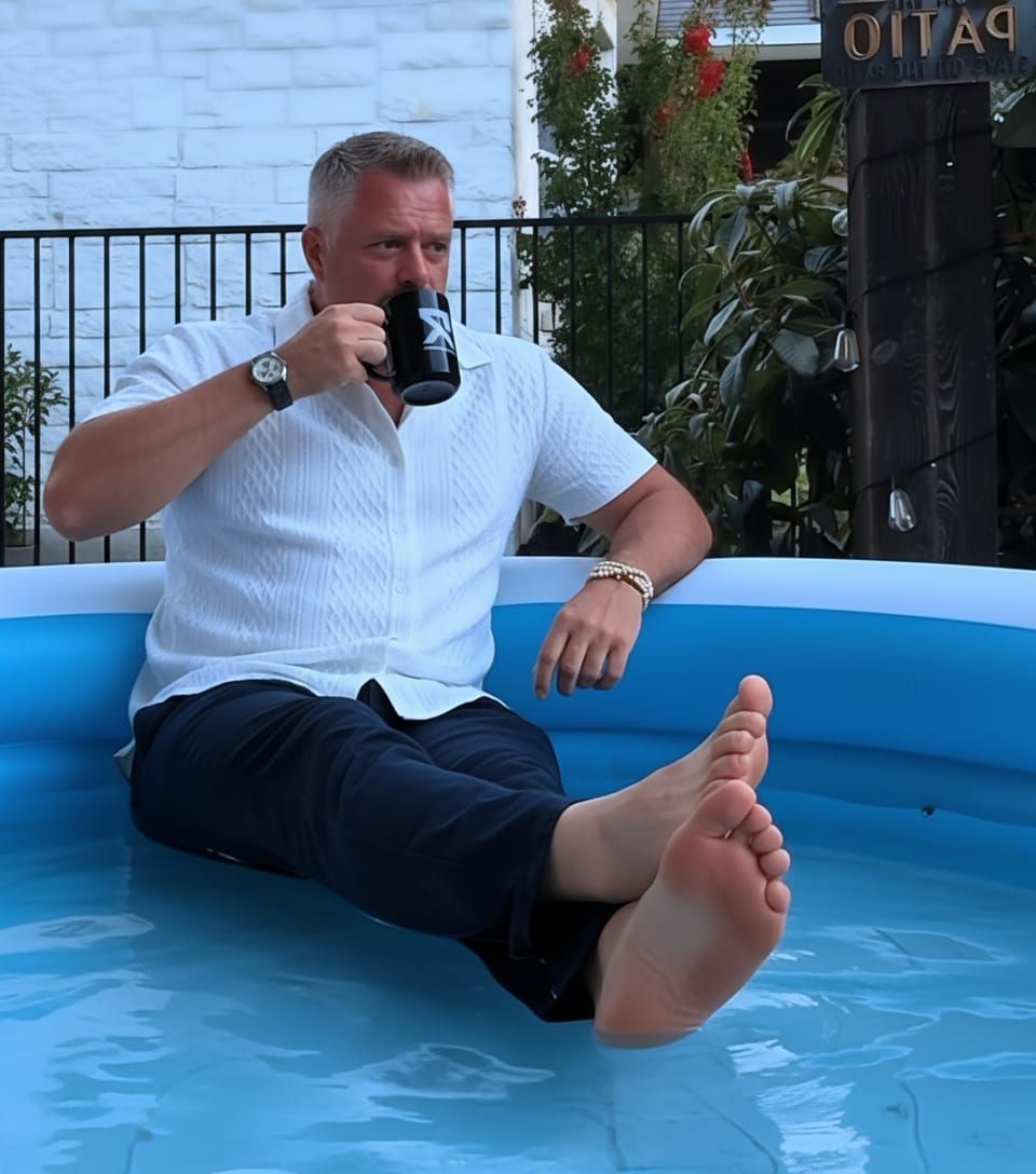 Man Relaxing in Inflatable Pool with Coffee