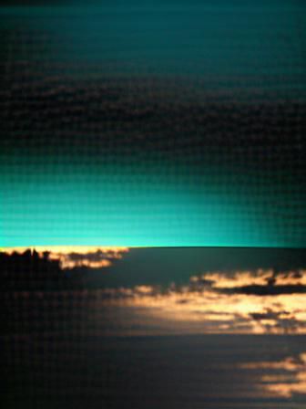 Striking Dawn Horizon in Black, Cyan, and Green