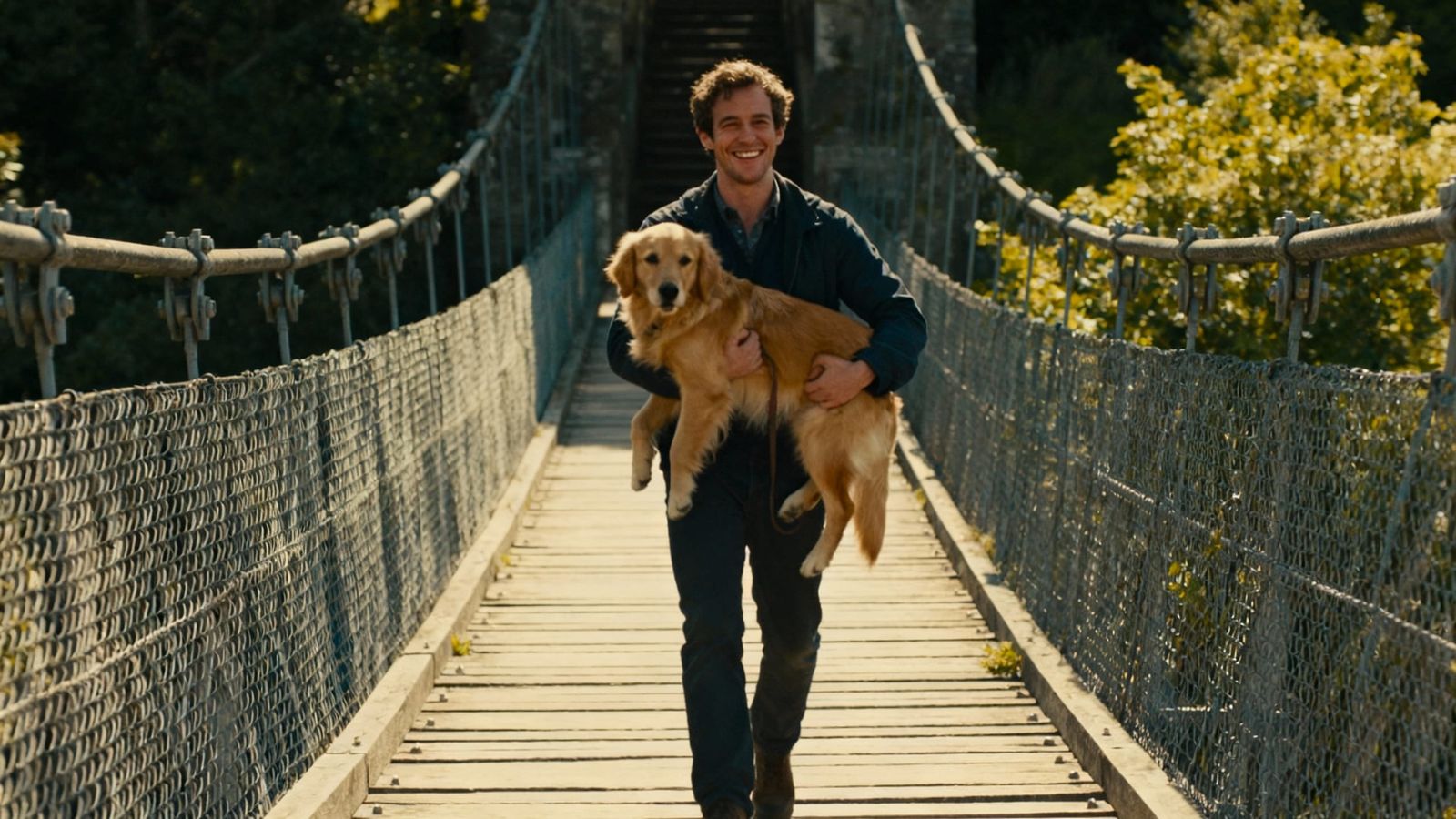 Man and Golden Retriever Walk Up Bridge on Sunny Day