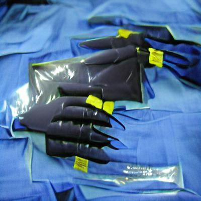 Surgical Gloves on Dark Backdrop