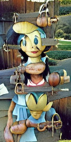 Wooden Girl Crushes Cricket at Ranch Gates