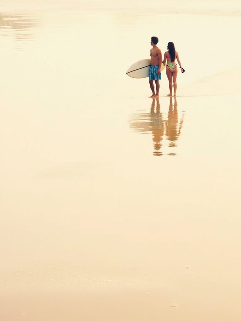Vibrant Beach Scene with Surfboard Reflections