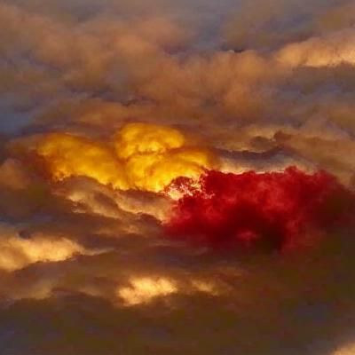 Fiery Sunset Over Pillowy Clouds