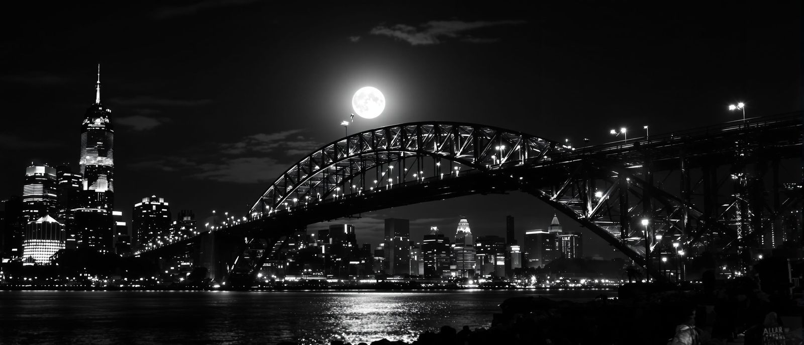 Dramatic Black and White Nocturnal Cityscape with Bridge