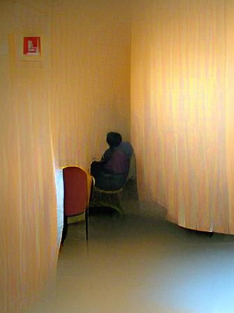 Person in Corner of Room with People