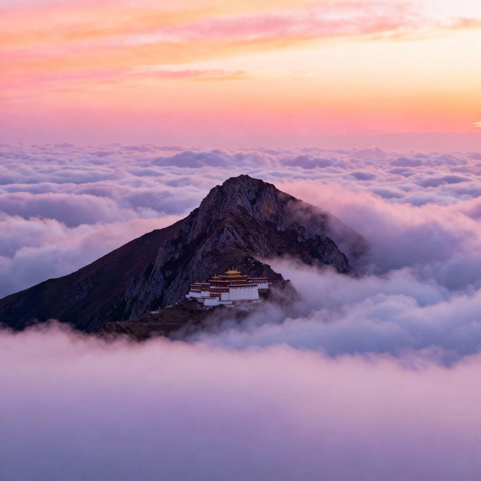 Ethereal Mountain Peak at Sunrise with Hidden Monastery