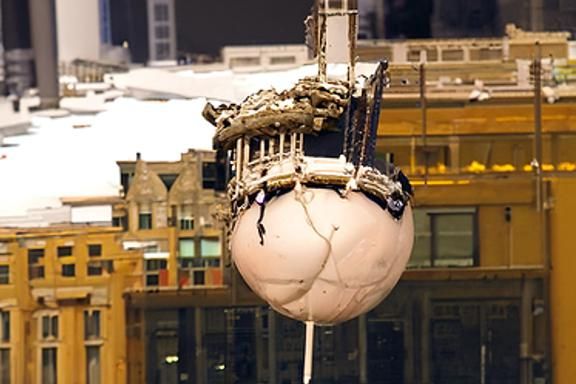 A wrecking ball dangling over the skyline of Chicago (Start ...