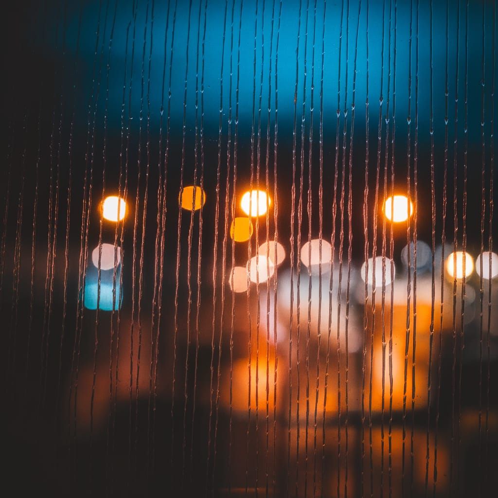 Rainy City Night Scene in Moody Blues and Amber Tones