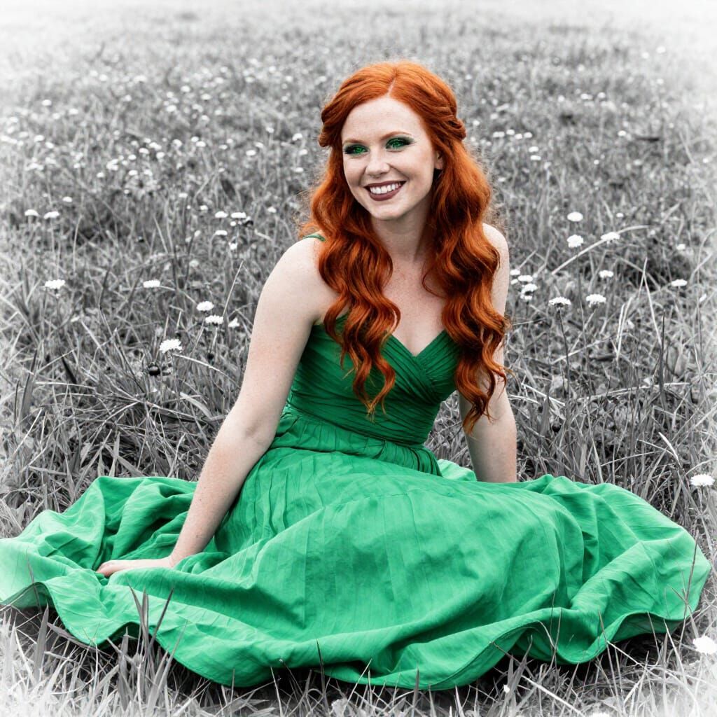 Red Haired Woman in Green Gown Sitting in Field