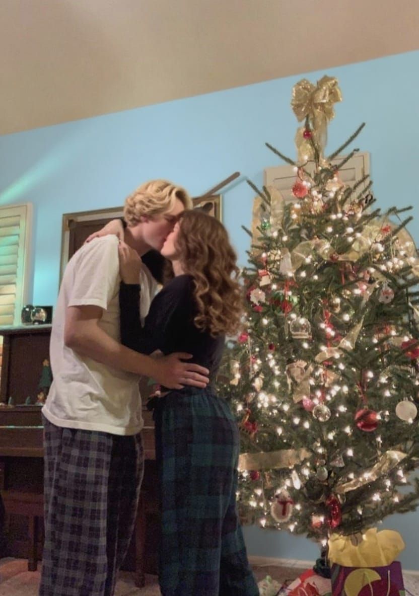 Couple Posing with Light Blue Wall Background