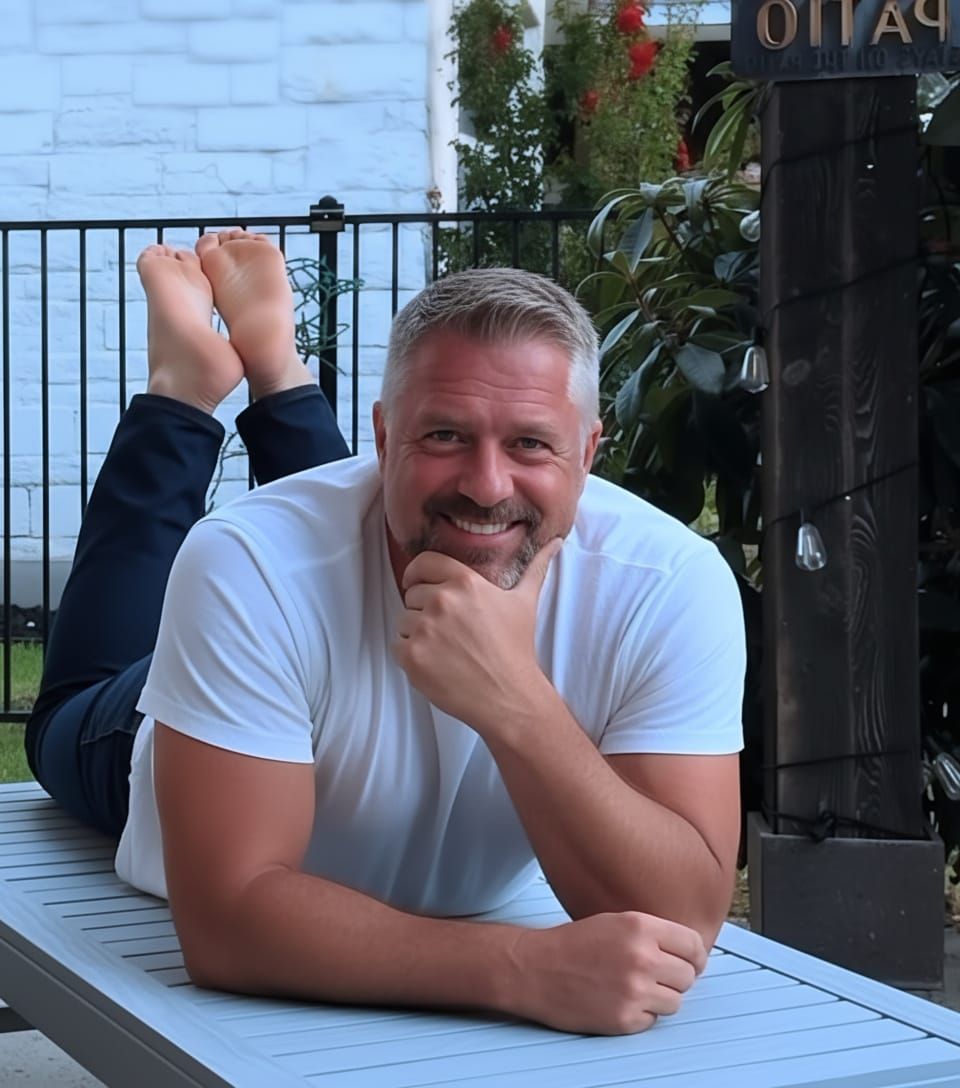 Man in Jeans and T-shirt Rests Chin on Hand