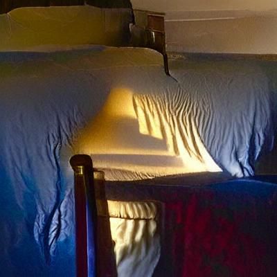 Eerie Shadow Over Bed in Dim Light