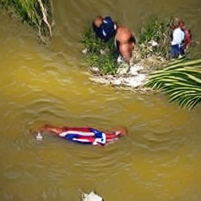 Man in Suit Happily Stands in River