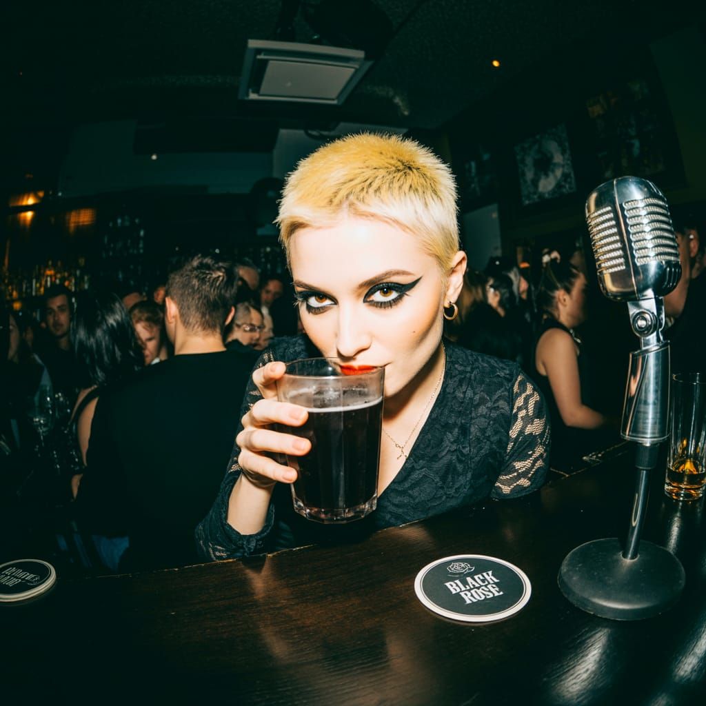 Goth Woman with Blonde Hair at Bar