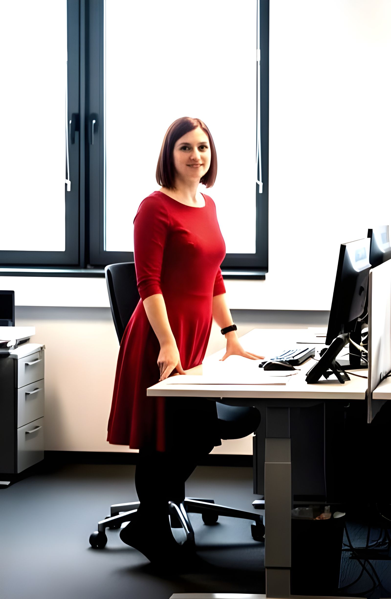 Candid Office Photo: Woman in Red Dress Next to Desk