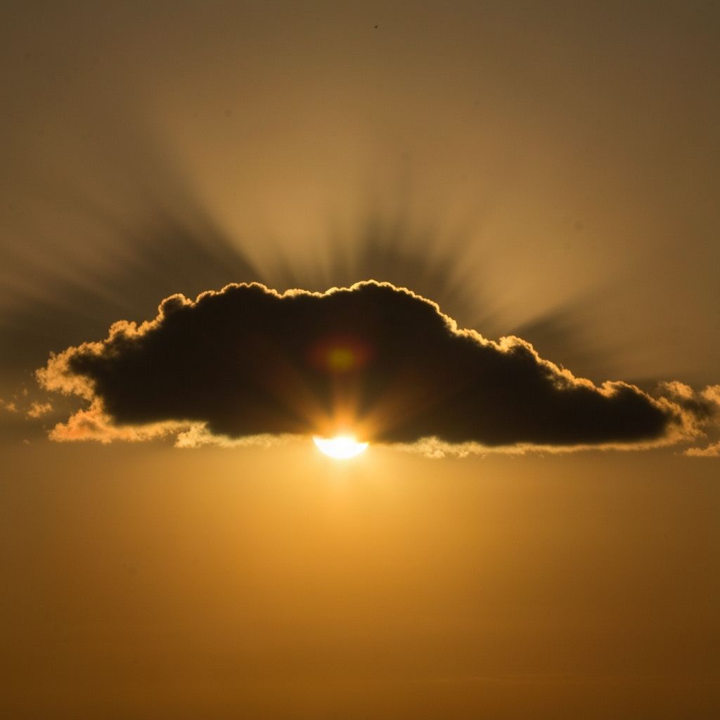 Sun Blindingly Bright Behind Dusk Cloud Silhouette