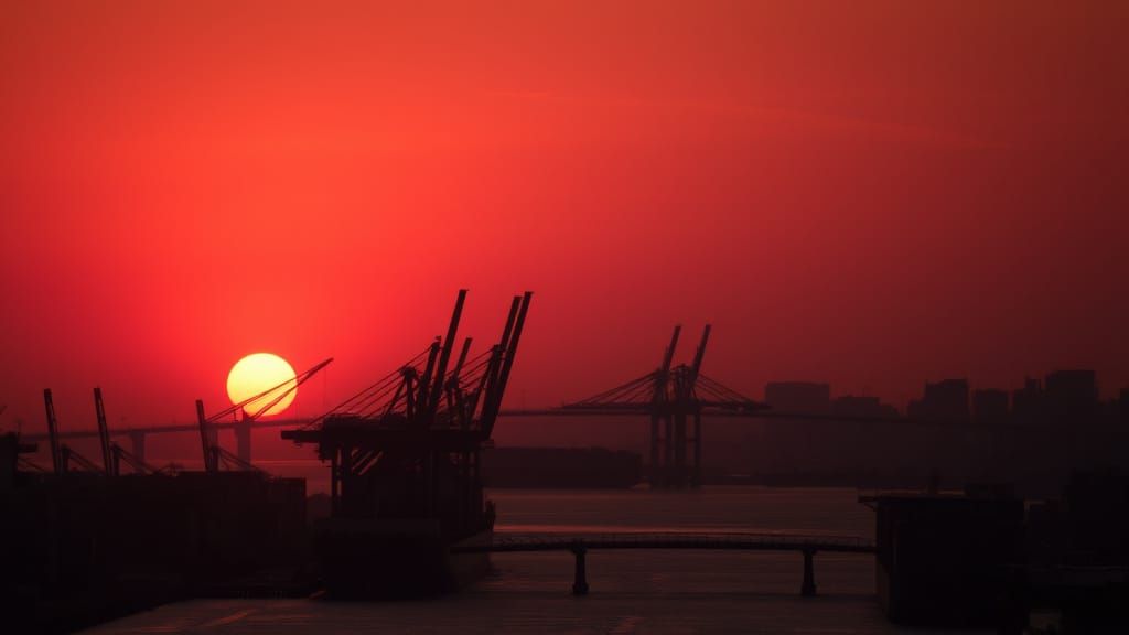 Orange Sunset Over a Busy Industrial Port