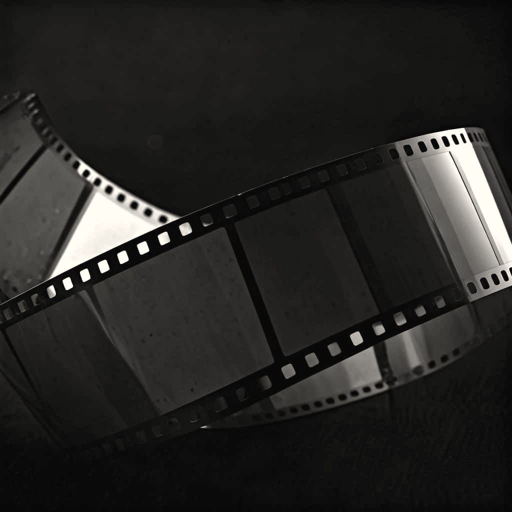 Unraveling Film Reel in Noir Movie Theater