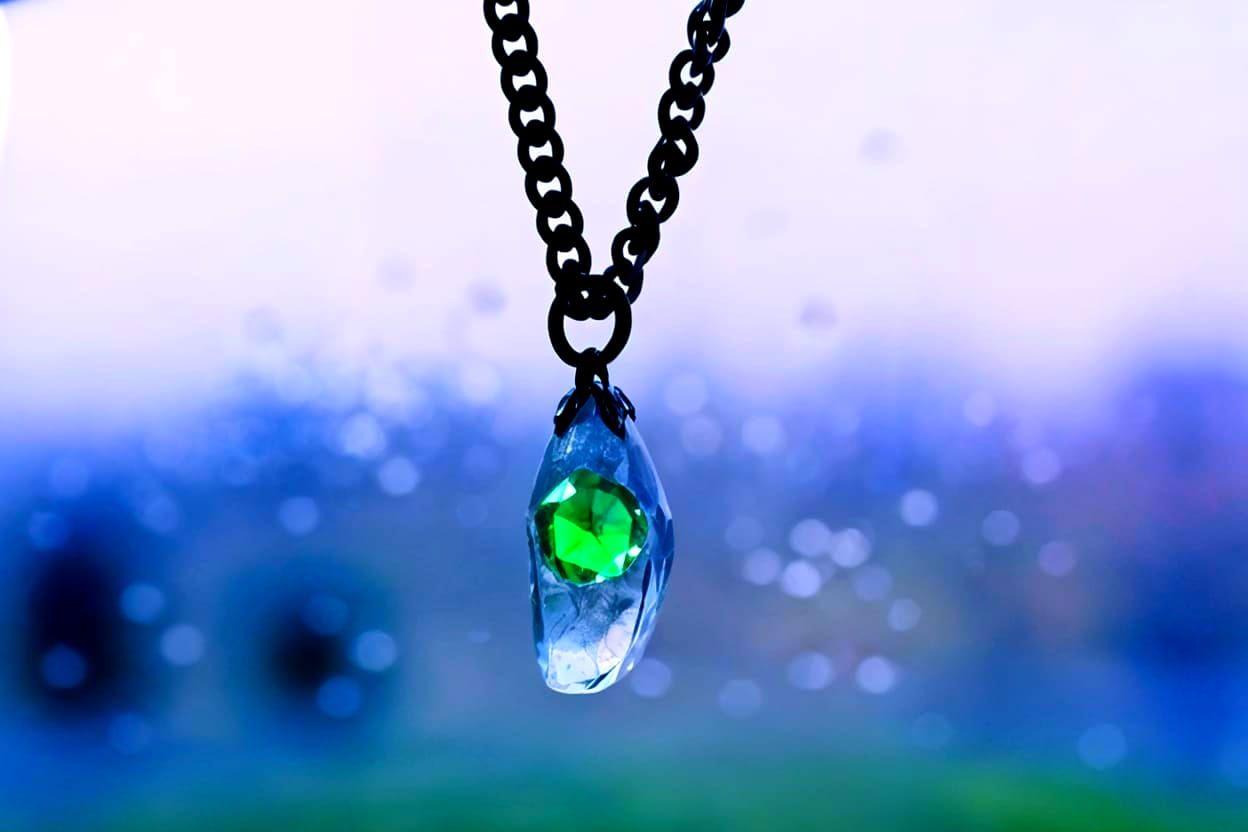 put a tiny green emerald inside the crystal