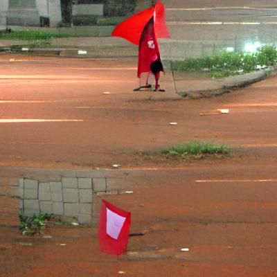 Person with Red Flag on City Street
