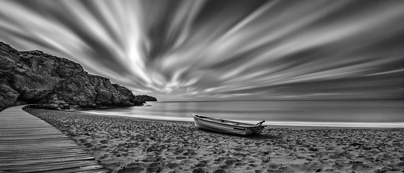 Surreal Black and White Coastal Scene with Boat on Sandy Sho...