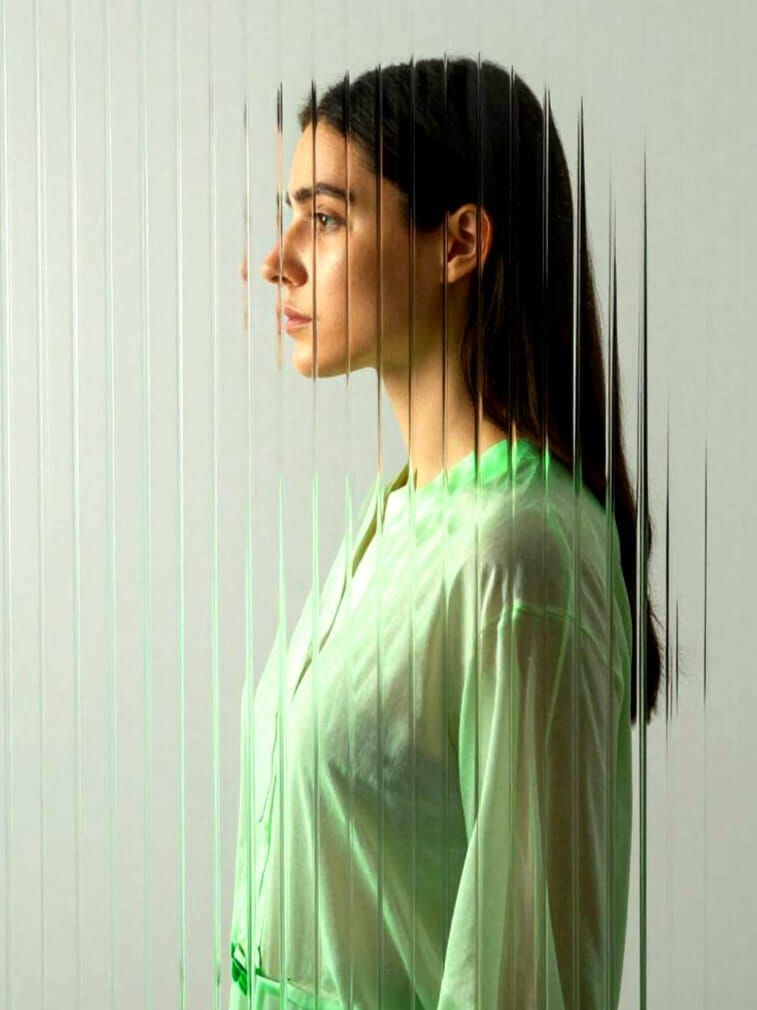 Woman's Portrait Distorted Through Reeded Glass