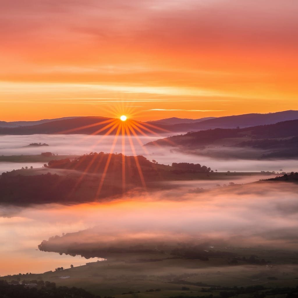 Spectacular Sunrise Over Tranquil Lake in Vibrant Colors