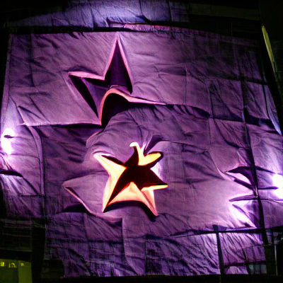 Purple Star Illuminates Night Sky