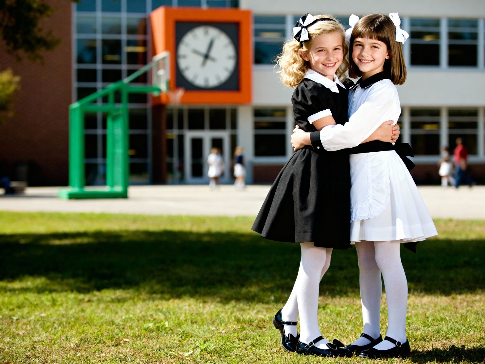 Joyful Girls Embrace in Schoolyard Photograph
