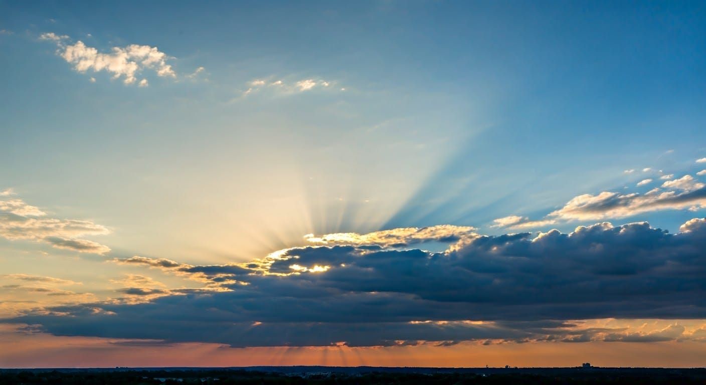 Sun Rays Diffusing Through a Cloudy Blue Sky