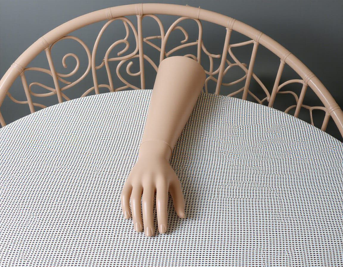 A Solitary Hand Rests on a Table
