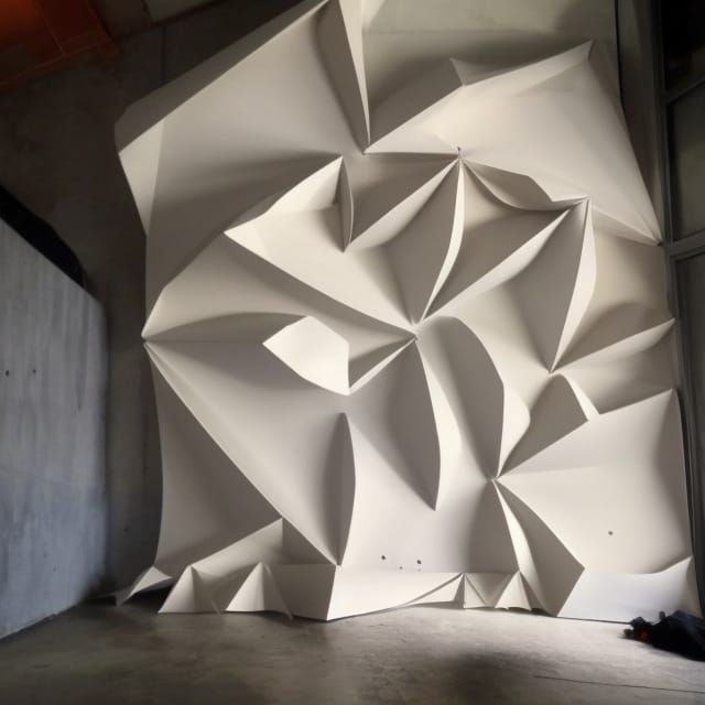 Brutalist Building with Origami Wall and Vertical Gardens