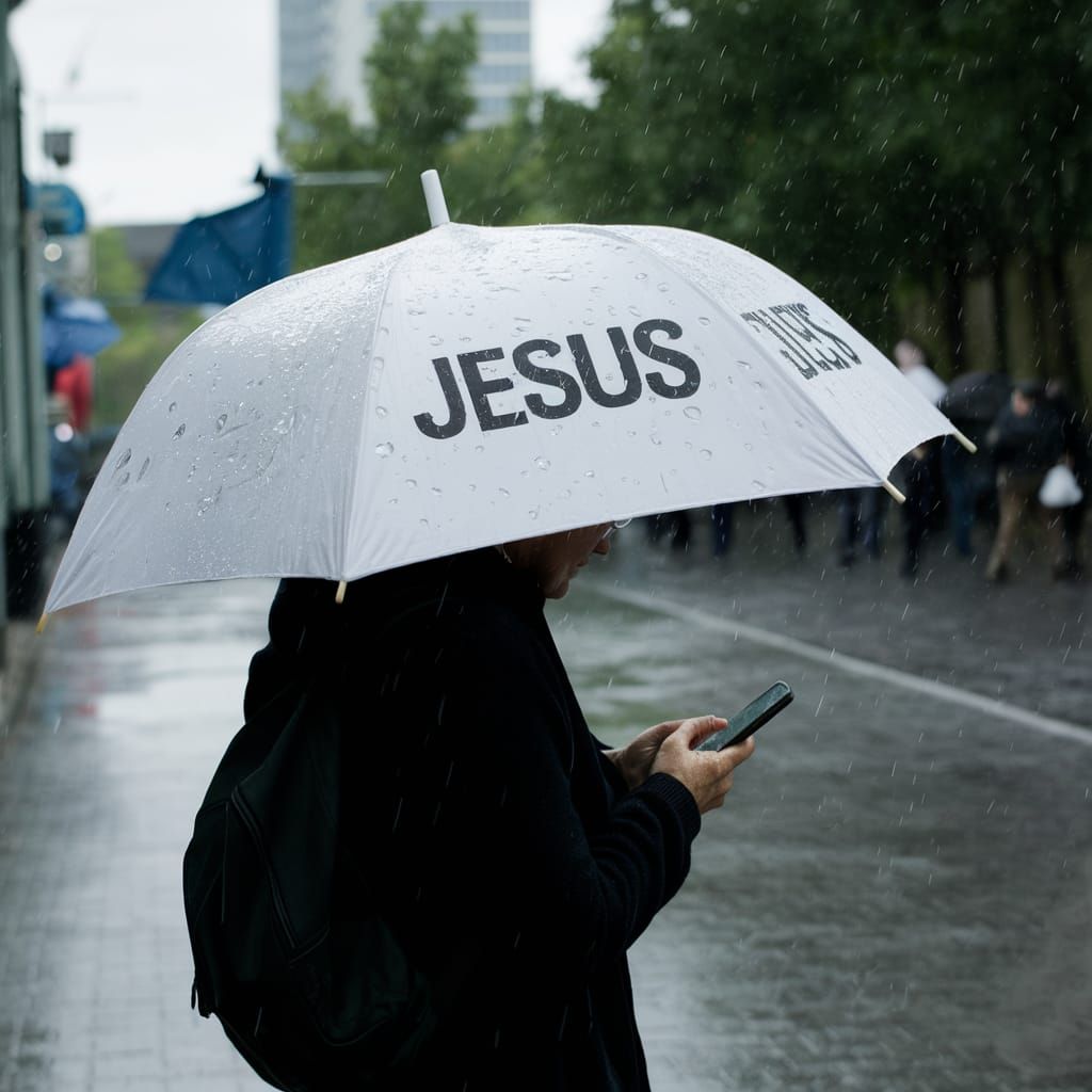 Person with Jesus Umbrella in the Rain
