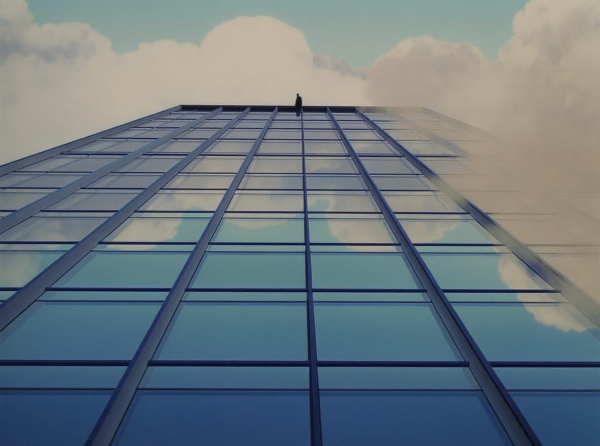A figure looking down from a skyscraper edge.