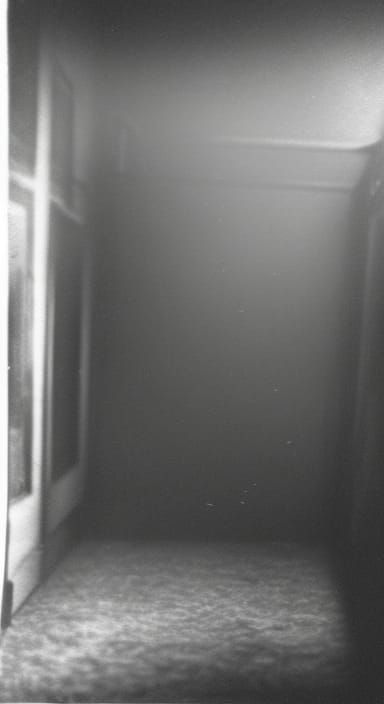 CCTV footage of shadow figures hiding in a dark morgue