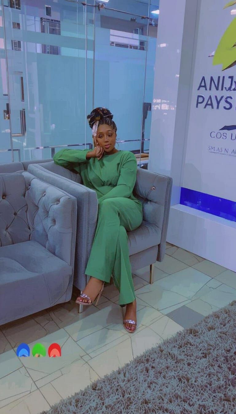 Woman Relaxing in Stylish Two-Piece Outfit with Hat