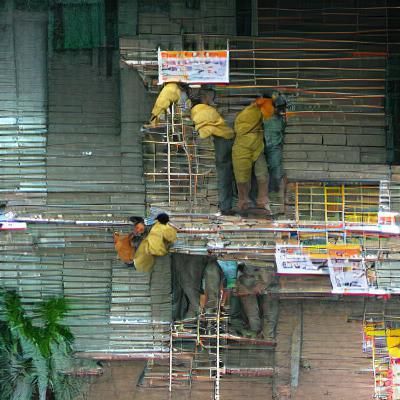 Construction Workers Erecting Scaffolding on Building