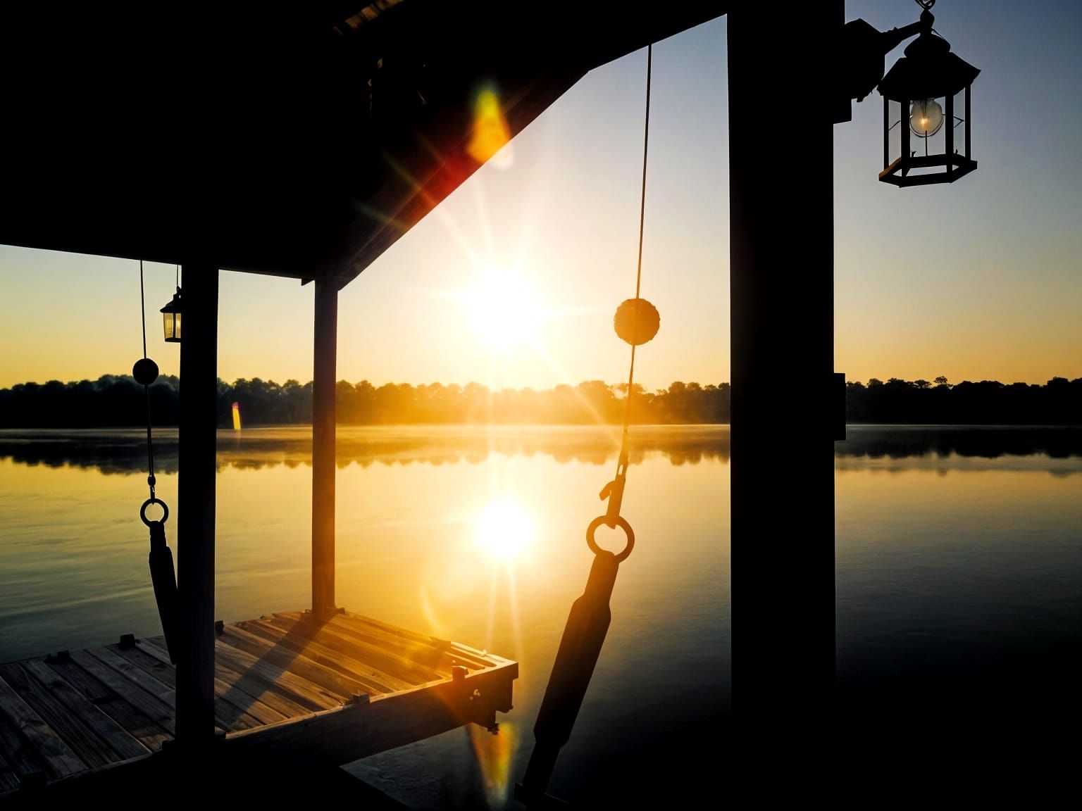 Sunrise Over Mississippi Lake Through Boathouse