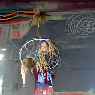 Girl with Dreadlocks Holding a Dreamcatcher