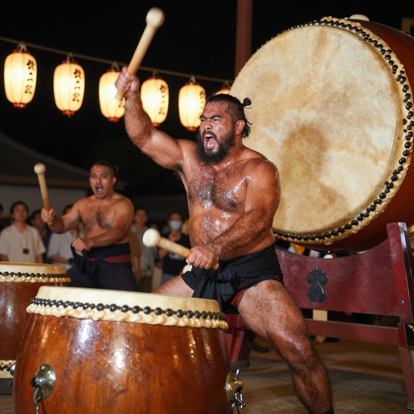 Battle-Hardened Taiko Drummer in Festival Lanterns