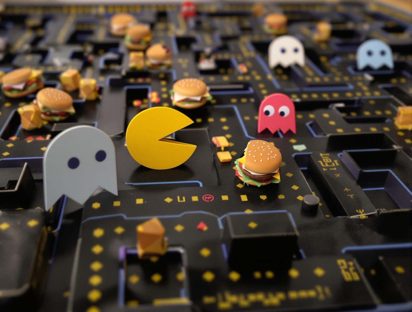 Pac-Man in a Paper Maze, Chased by Ghosts with Hamburgers