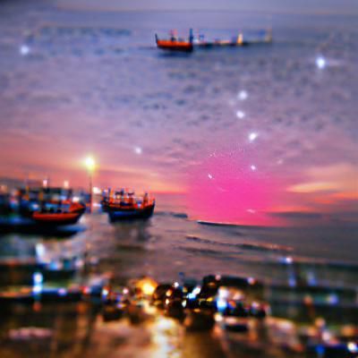 Sunrise Over the Sea: City Lights Fade