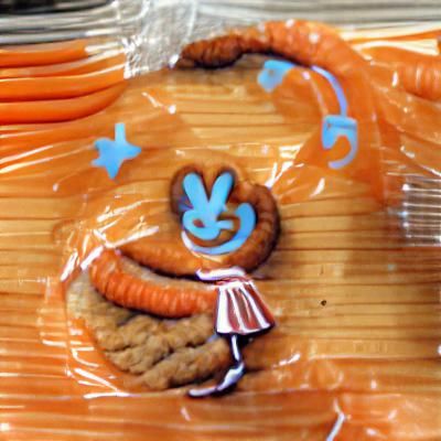 Smiling Carrot Cookie with Blue Pigtails