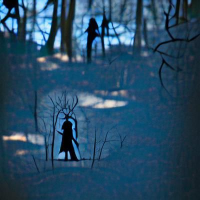 Eerie Silhouettes in Dark Forest Landscape
