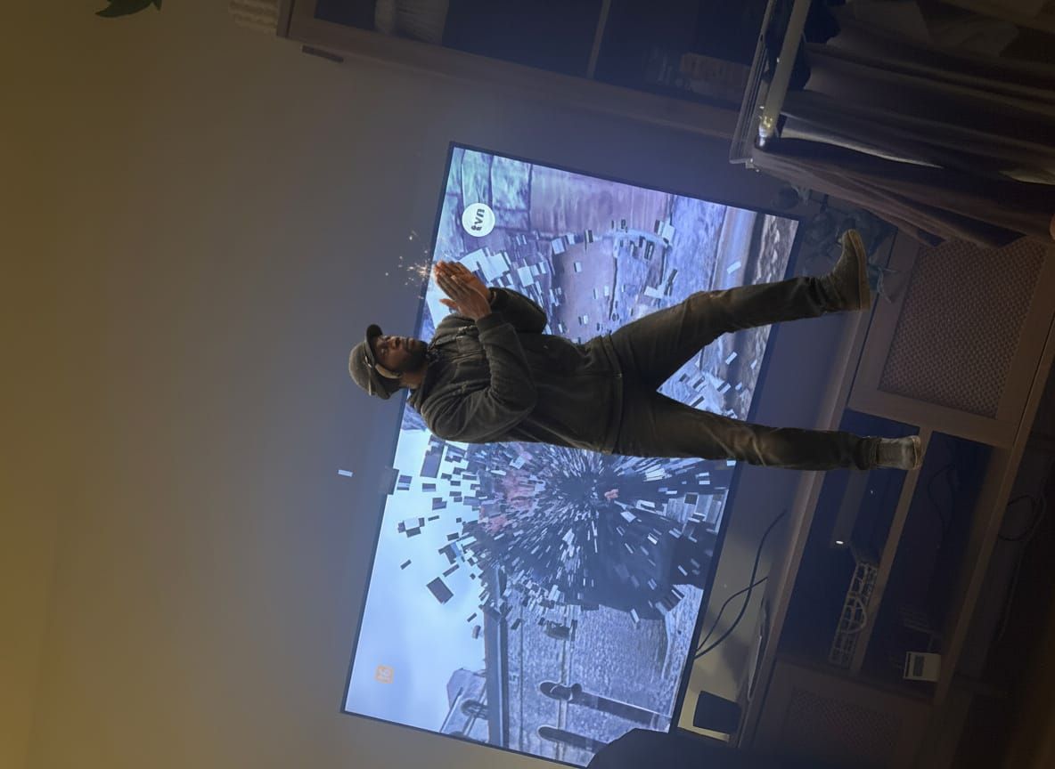 Man Dances on Head Emerging from TV Screen