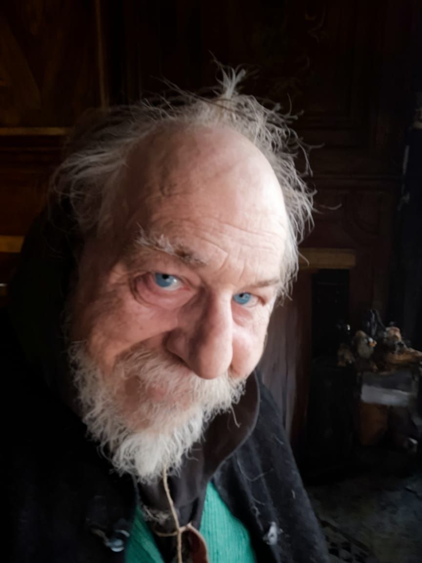 Disheveled Gentleman with Vivid Blue Eyes