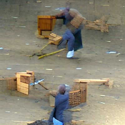 Man Breaks Crates with Crowbar